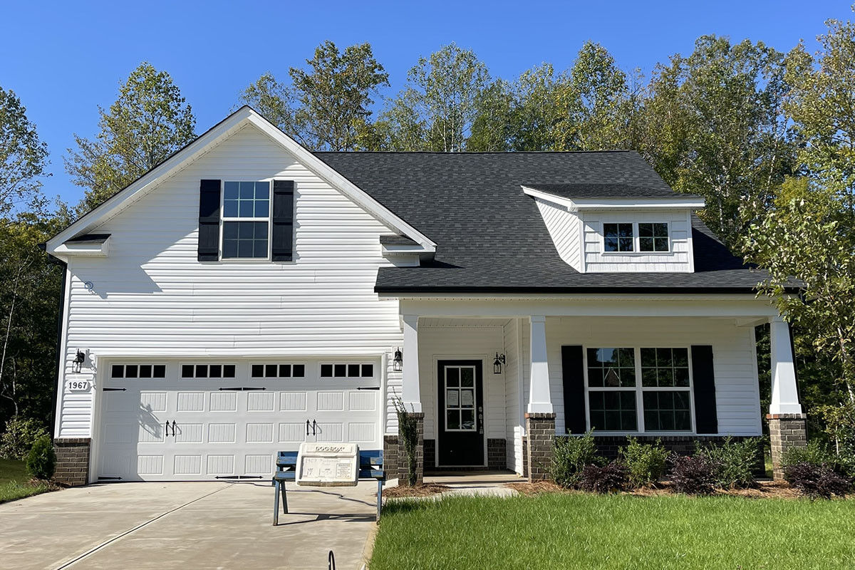 https://assets.windsorhomes.us/img/MVG_lot 17_Cary A_1967_Meadowview_Dr_exterior_full_front_grass_crop.jpg